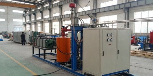 PU Foaming Machine A high-pressure PU foaming machine in a factory setting