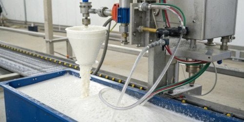 A PU foaming machine mixing head dispensing liquid into a mold