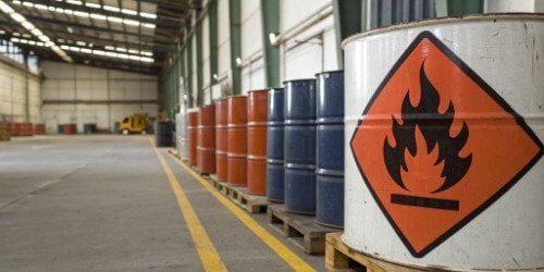 A fire safety sign next to barrels of cyclopentane