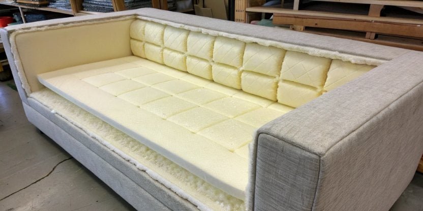 A cross-section of a sofa cushion showing the finished polyurethane foam inside.