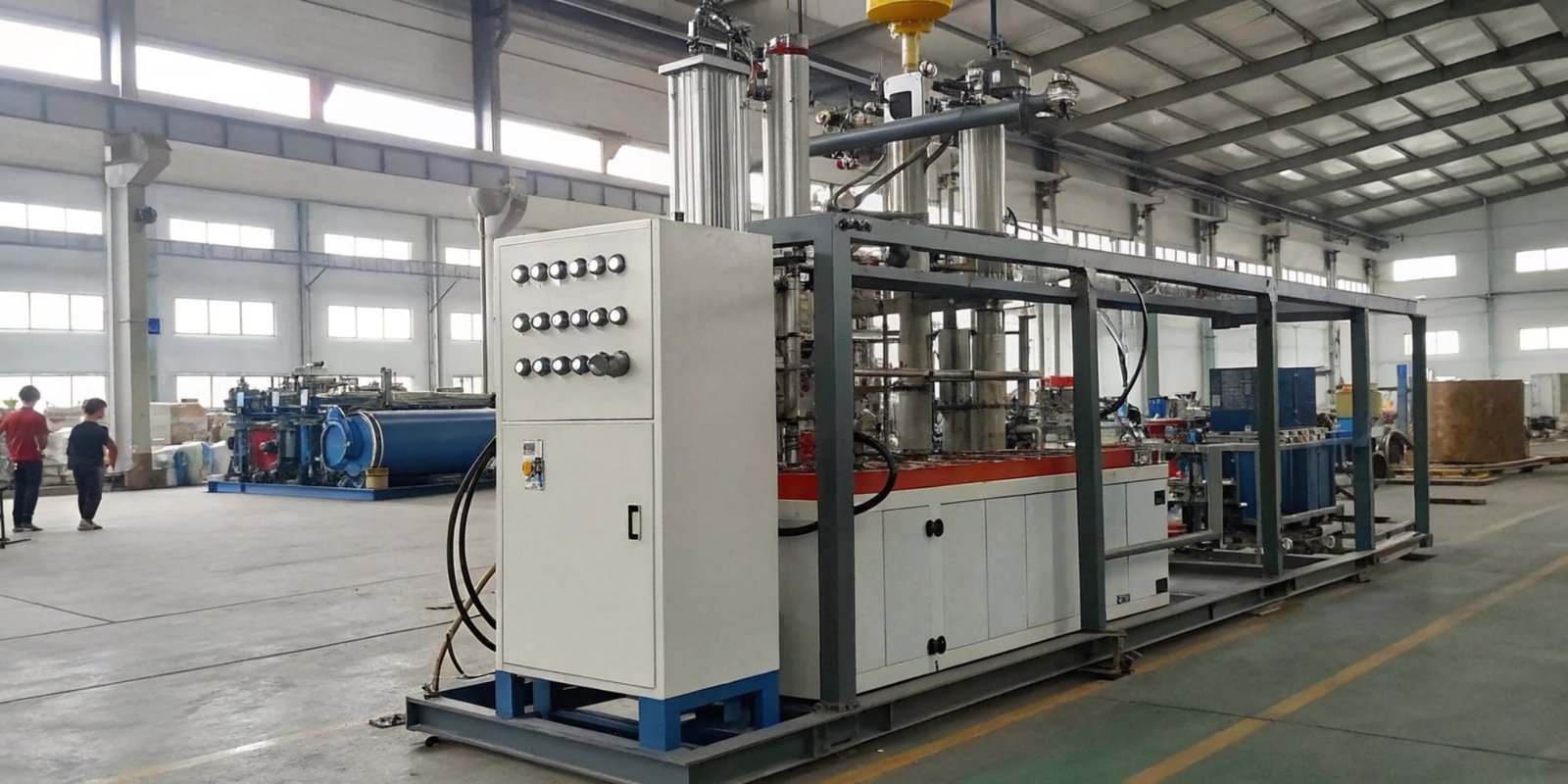 A modern high-pressure PU foaming machine in a factory setting